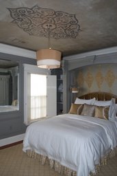 Design on ceiling and wall behind bed