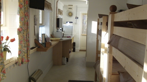 a view towards the kitchen area. complete with m/wave oven.