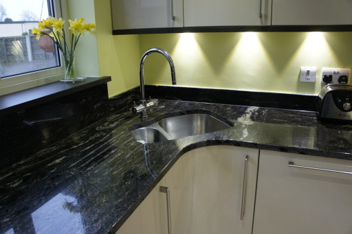 Corner sink on a Metris matt sand door with Wenge wood and cosmic granite