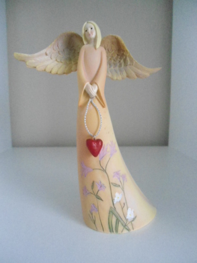 A beautiful angel holding a heart