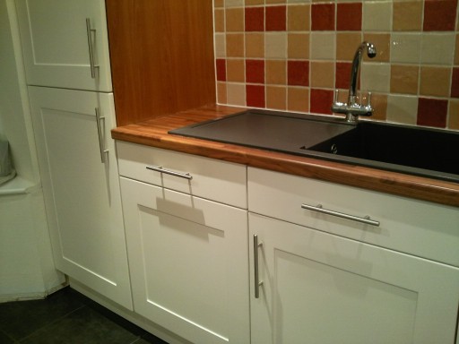 Interior design shaker kitchen with cream units and walnut work tops.