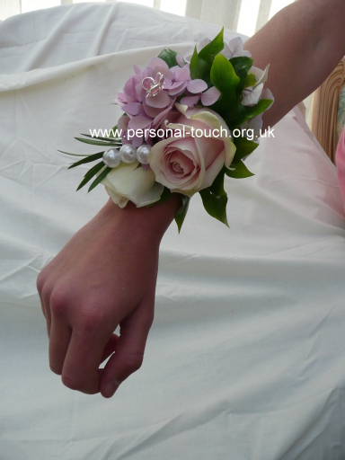 Wrist corsage of roses,hydrangea and pearls.