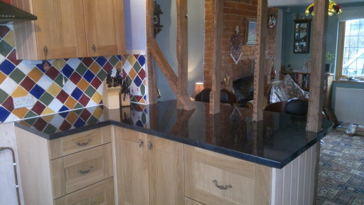 Black gloss laminate fitted arround wooden beams