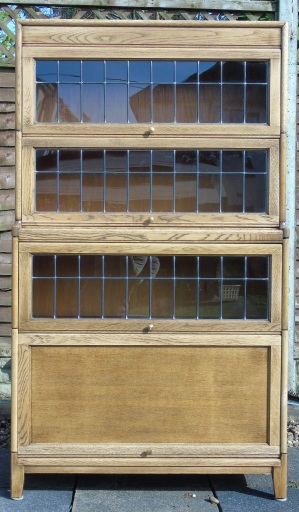This cabinet had been originally stained dark, but now has been stripped and varnished to reveal the