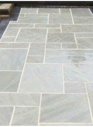 Raj natural sandstone patio with wooden decking