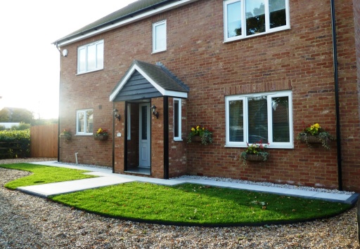 New tilesd porch on executive home, granite paving and lawn