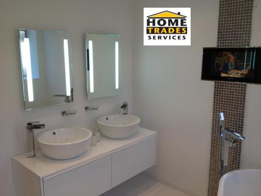 His n' Hers basins with mirrors and bathroom TV