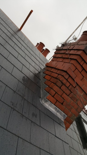 FIBRE CEMENT SLATE ROOF AND LAEAD WORK AROUND CHIMNEY STACK.