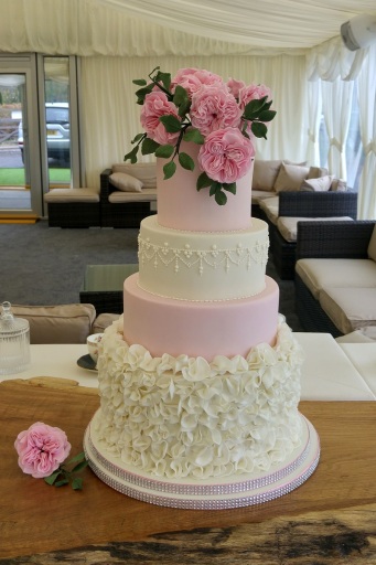 Ruffles and Roses... Pearls and lace. Beautiful wedding cake.
