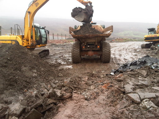 360 excavator loading articulated dumptruck