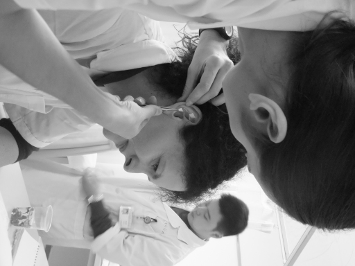 Emma Van Loock Lic.Ac inserting 'ear press seeds' during clinical internship in Nanjing, China