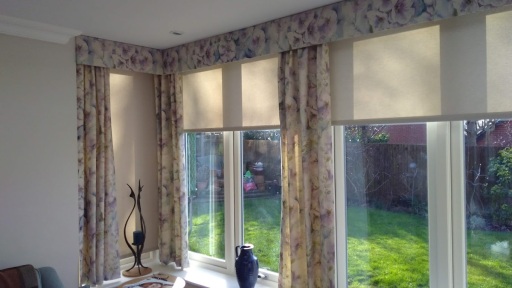 Dress curtains with roller blinds in a conservator