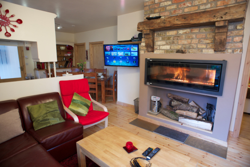 Coach house lounge with panoramic wood burning stove, seats 8 in dining and lounge area