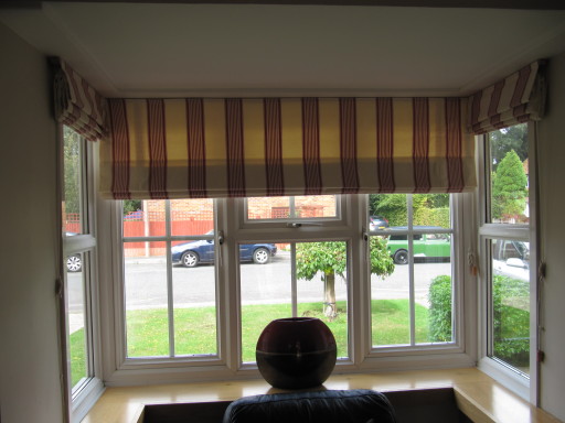 STRIPED ROMAN BLINDS USING ROMO STRATTON FABRIC IN A BAY WINDOW