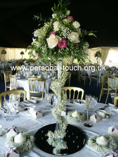 Table arrangement of roses, gyp and eustoma.