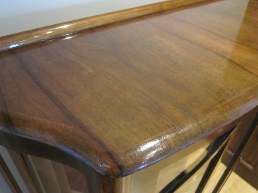 The top of this display cabinet had dull wood with degraded varnish and some veneer chips missing.