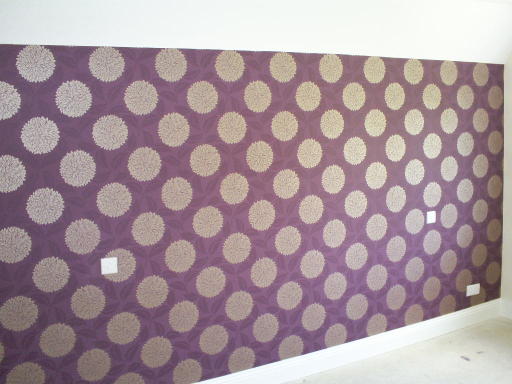 A wallpaper feature wall in this bedroom
