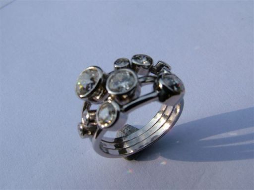 Made platinum ring,customer supplied stones.similiar to bootles ring.