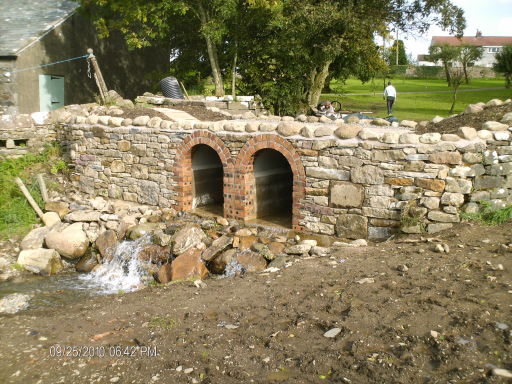 bridge water feature with patio area above.