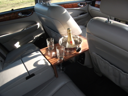 Luxurious pale grey leather seating and walnut trim,