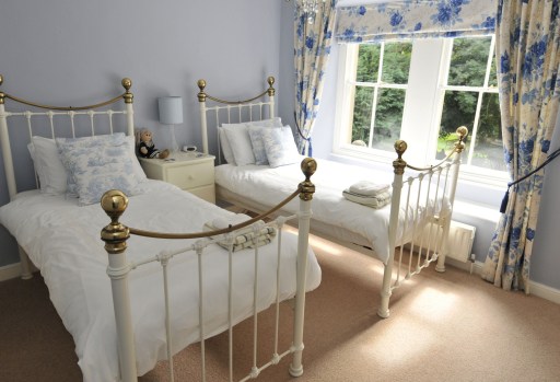 Individually designed bedroom with views over Knowleston Gardens