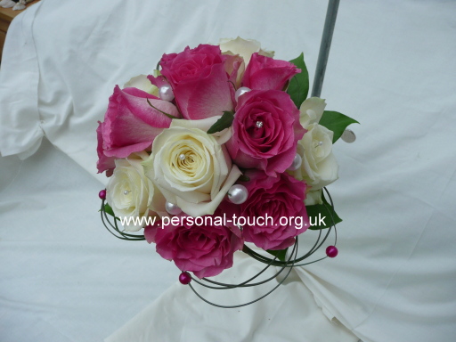 Hand tied of pink and white roses.