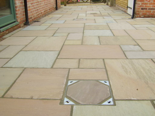 Indian Stone Paving Forest Green with inlaid manhole cover