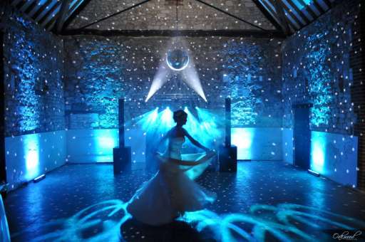 Bridge dancing at her wedding with DJ lighting, moving heads, uplighting and mirror ball