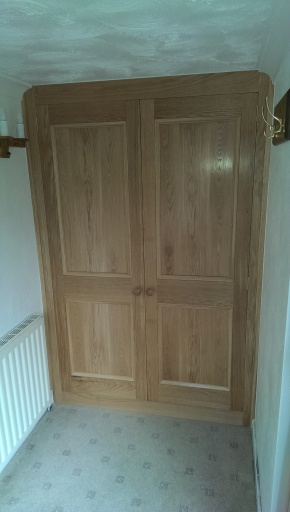 Hall cabinet in oak with panelled doors