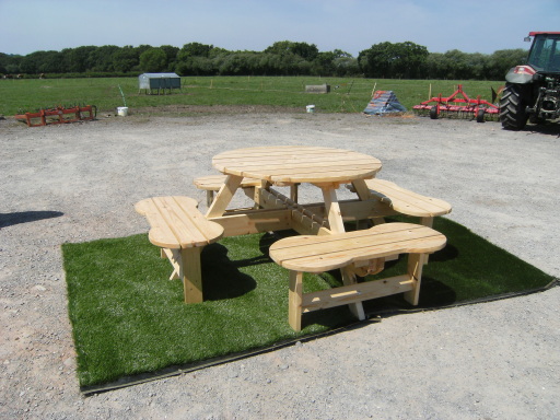 Comfortable large seated Round Table. ( Treated Redwood )