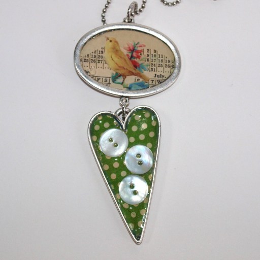 Retro style pendant necklace with polka dot and bird imagery