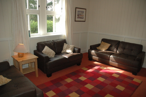 The sitting room at West Lodge, Couldoran is comfortable and spacious and has a wood burning stove.