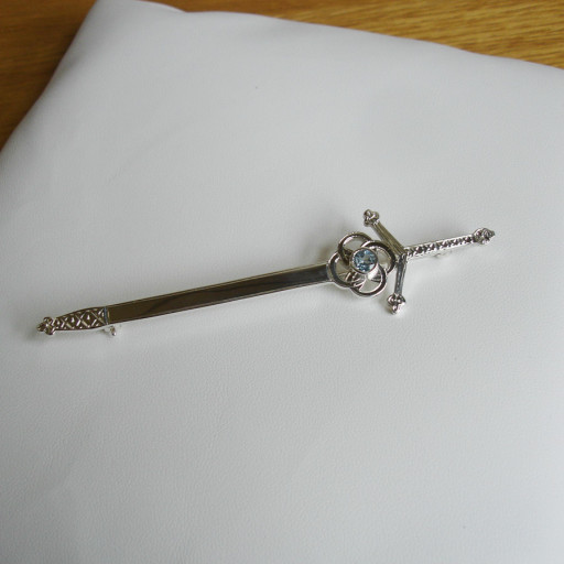 Hand made silver kilt pin set with a blue topaz.