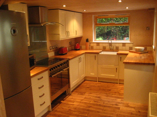 Kitchen renovation in Churton. Cream kitchen units with a oak worktops
