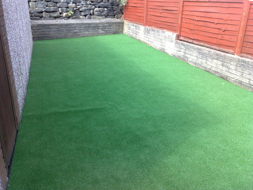 Artificial grass stuck directly onto concrete making a safe play area for children