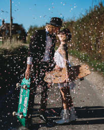 Couple kiss with confetti and skateboards