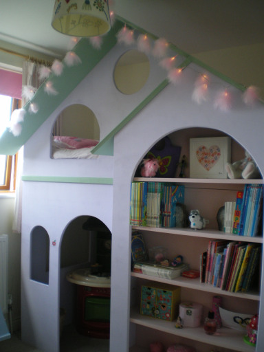 Girl's bed on the top with dolly house underneath