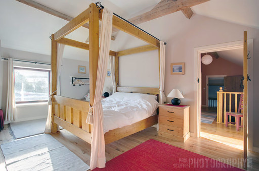 first floor bedroom featuring king size 4 poster bed