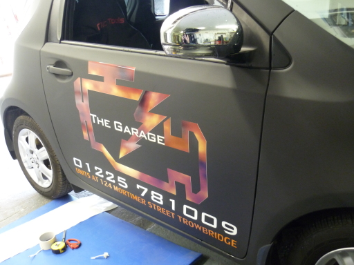 Toyota fully wrapped in super matte black, with reflective livery applied