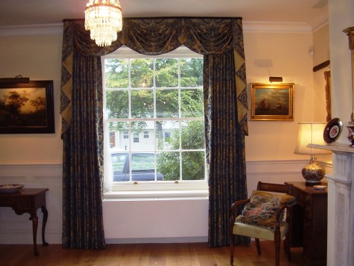 Long hand made curtains with swags and tails