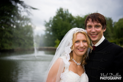 The couple posing before Breads Priory's fountain