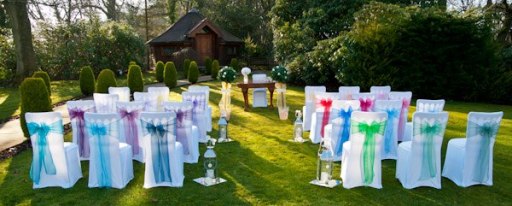 multi coloured chair covers and organza sashes