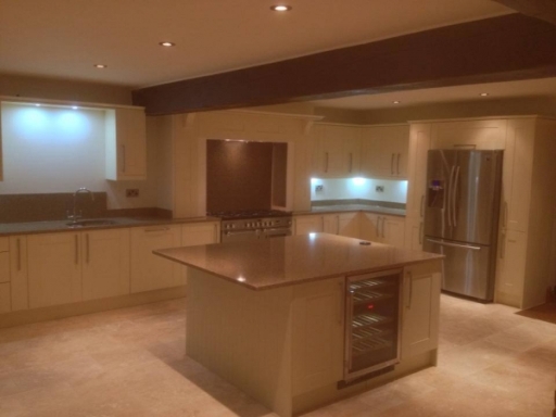 A bespoke solid oak handpainted kitchen with granite worktops and feature mantle