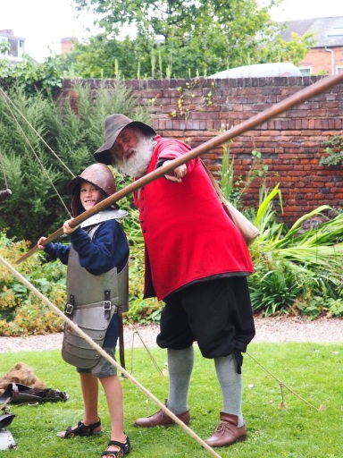 A child tries costume and pike drill at The Commandery