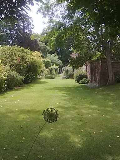 A classic child friendly garden designed to draw the eye to the distance.