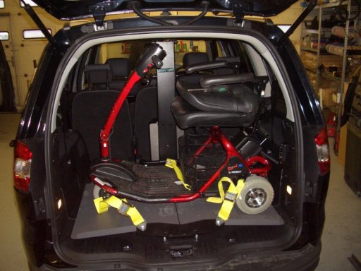 A mobility Scooter loaded into the rear of a vehicle