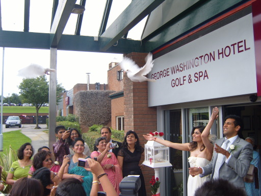 Happy couple releasing their doves on their wedding day