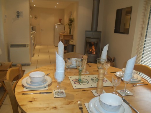 Cosy dining and kitchen with log fueled stove