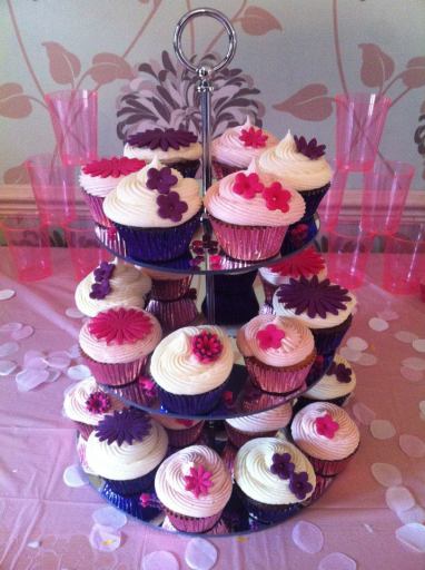 Pink strawberry cupcakes and purple chocolate cupcakes with assorted flowers