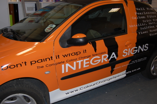 white van wrapped in orange and black
